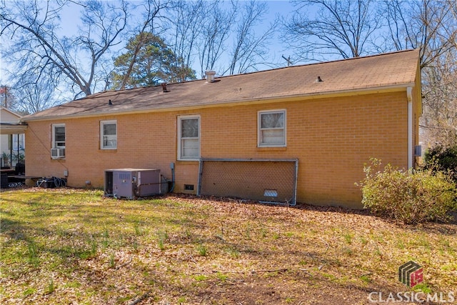 back of house featuring brick siding, central air condition unit, a lawn, cooling unit, and crawl space