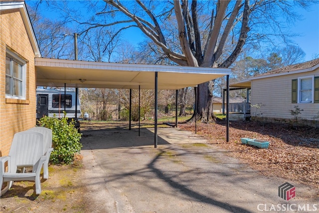 view of patio with a carport and driveway