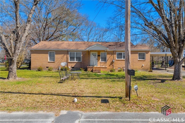 ranch-style home with a carport, crawl space, brick siding, and a front lawn