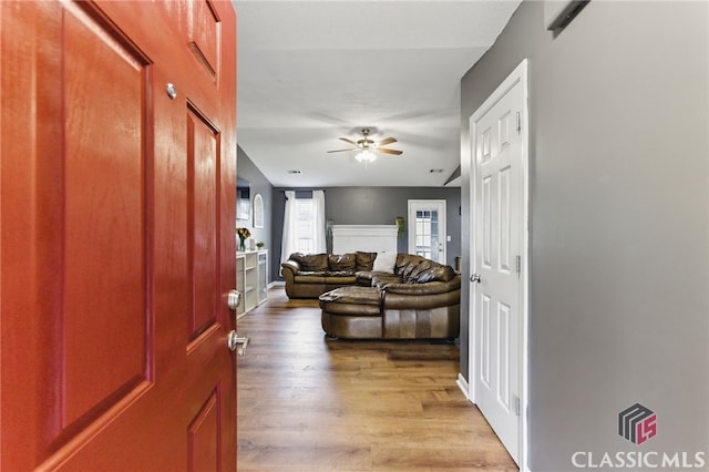 interior space with ceiling fan and wood finished floors