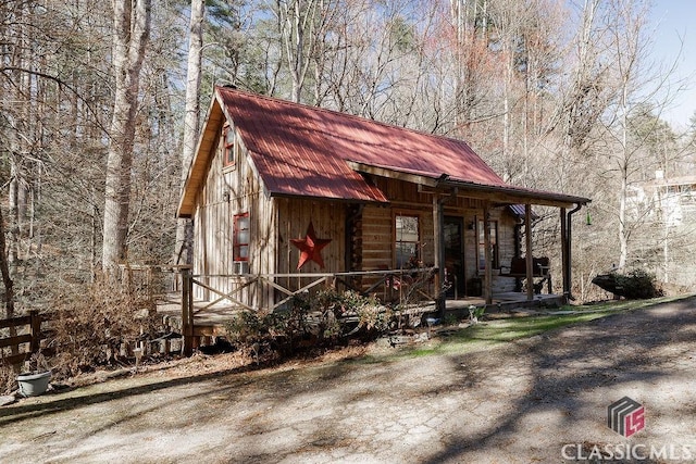 view of front facade with metal roof and a porch