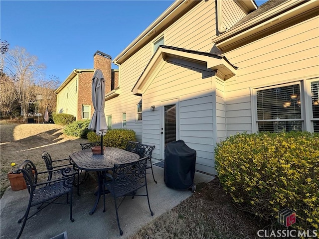 view of patio / terrace featuring outdoor dining area and a grill