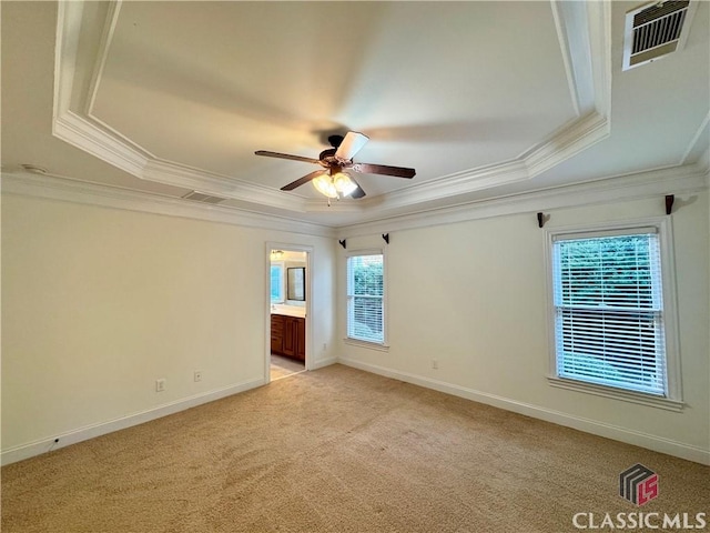 empty room with light carpet, visible vents, crown molding, and ceiling fan