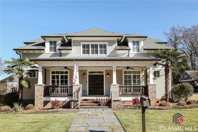 prairie-style home featuring a front lawn, covered porch, and ceiling fan