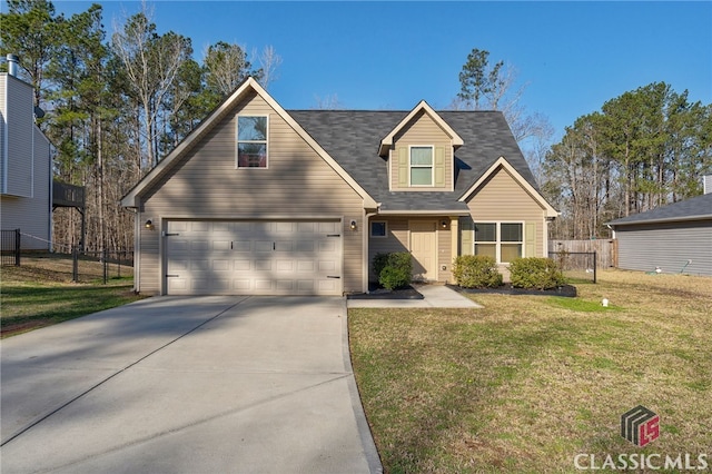 view of front of house with a front yard, driveway, and fence