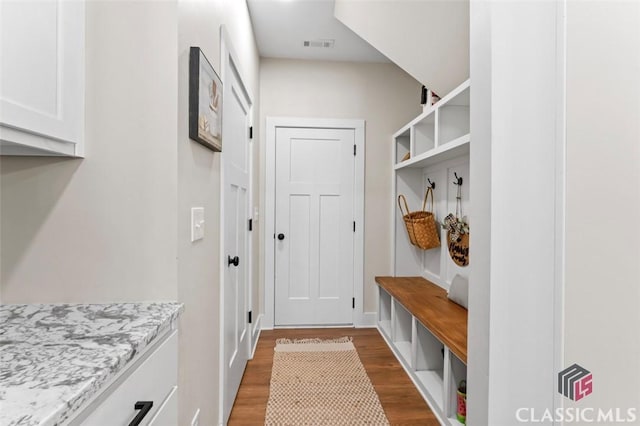 mudroom with visible vents and dark wood-style floors