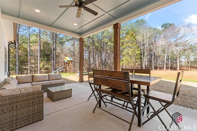 view of patio / terrace featuring outdoor dining space, an outdoor living space, a playground, and a ceiling fan