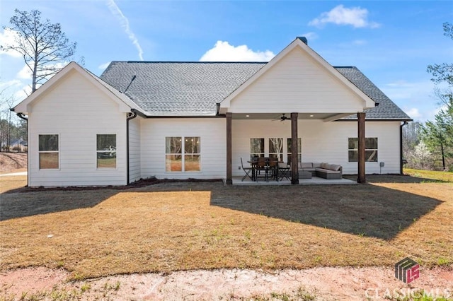 back of property featuring a yard, a patio, and ceiling fan