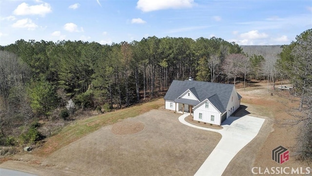 drone / aerial view featuring a forest view