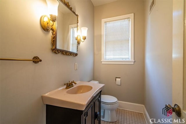 half bathroom featuring visible vents, toilet, vanity, and baseboards