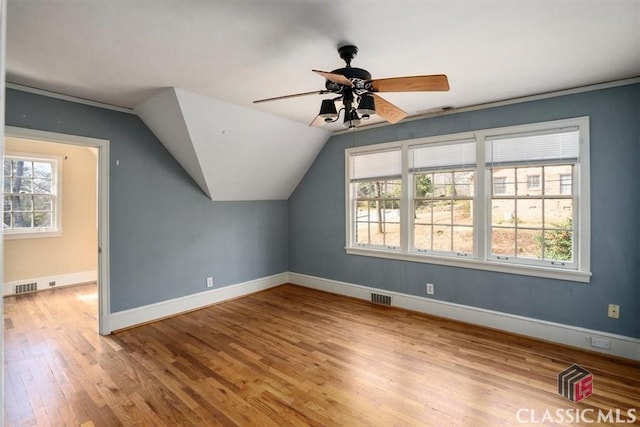 bonus room with visible vents, baseboards, and wood finished floors