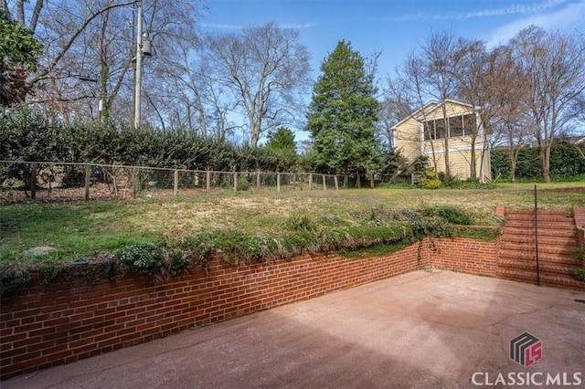 view of patio featuring fence