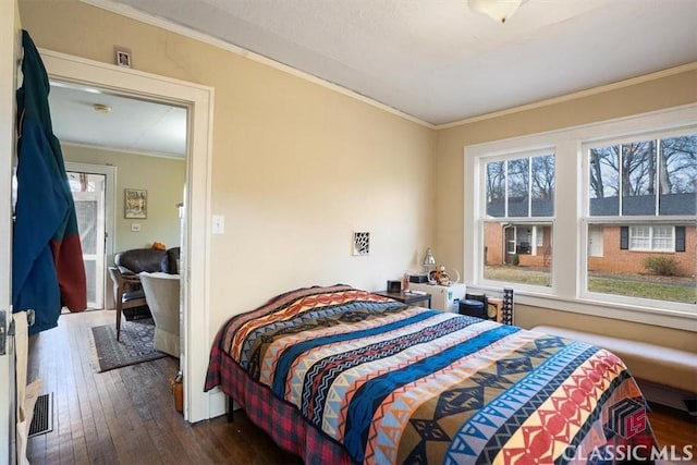 bedroom with dark wood-type flooring and ornamental molding