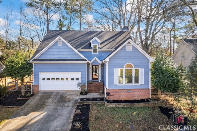 view of front facade featuring brick siding, an attached garage, concrete driveway, and fence