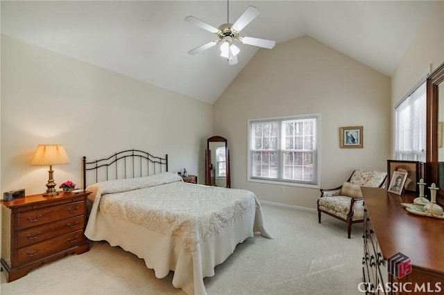 bedroom with multiple windows, a ceiling fan, baseboards, and light carpet