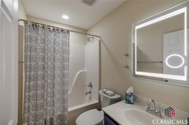 full bath with visible vents, toilet, vanity, and shower / tub combo