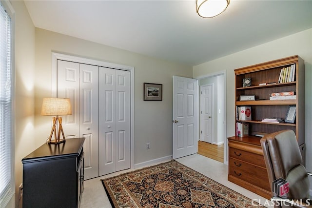 office space with light carpet and baseboards