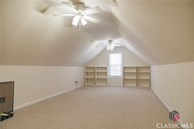 additional living space featuring baseboards, lofted ceiling, light colored carpet, and a ceiling fan