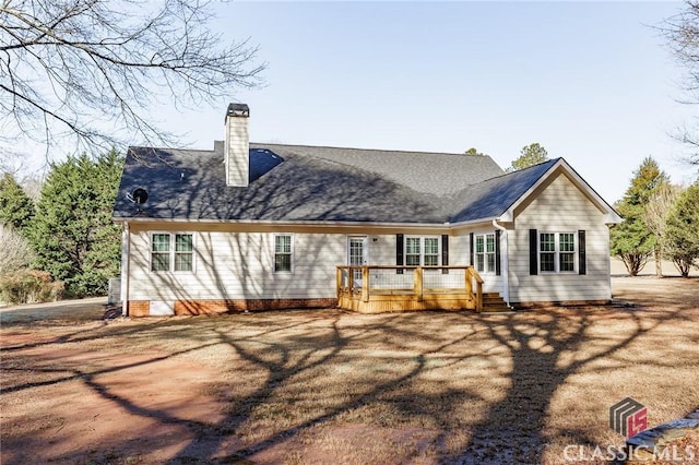 back of property with a deck and a chimney