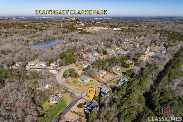 birds eye view of property featuring a wooded view