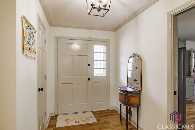 entryway featuring baseboards, wood finished floors, and crown molding