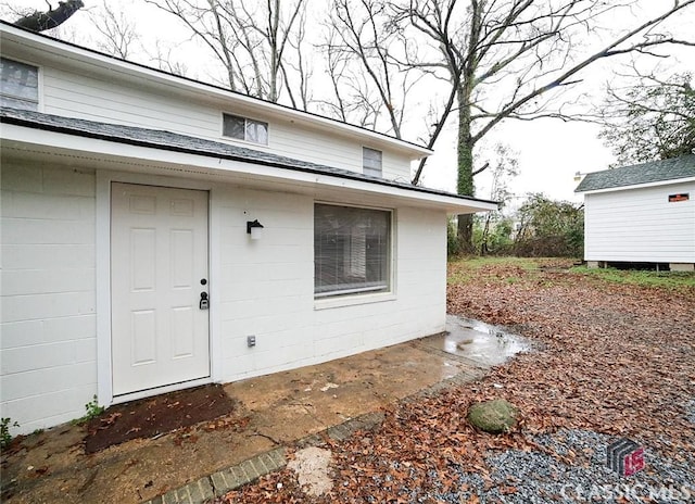 property entrance featuring concrete block siding