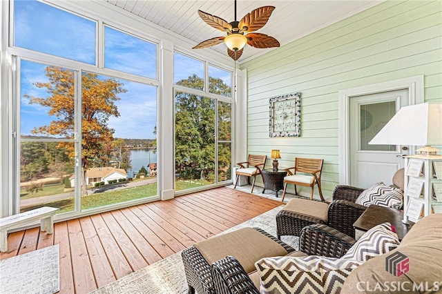 sunroom with a water view and ceiling fan