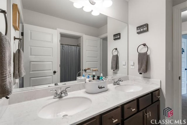 bathroom featuring a sink and double vanity
