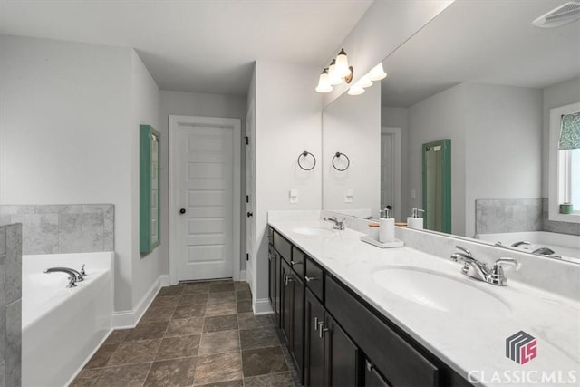 full bath with a sink, visible vents, a garden tub, and double vanity