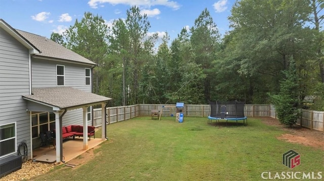 view of yard with a patio, a trampoline, and a fenced backyard