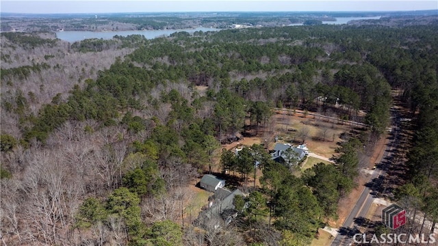 bird's eye view with a wooded view and a water view