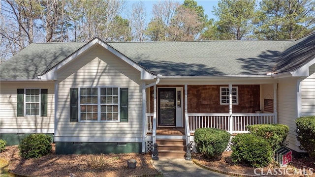 ranch-style home featuring covered porch, roof with shingles, and crawl space