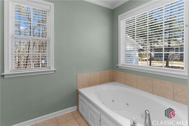 full bath featuring tile patterned flooring, a jetted tub, crown molding, and baseboards