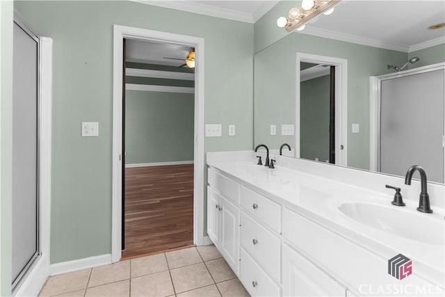 bathroom featuring a sink, ornamental molding, and tile patterned flooring