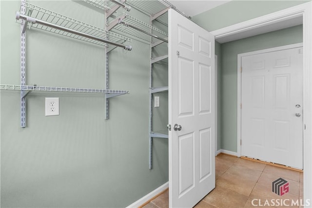 spacious closet featuring tile patterned floors