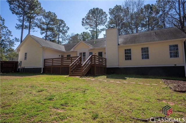 rear view of house with stairs, a wooden deck, a yard, and a chimney