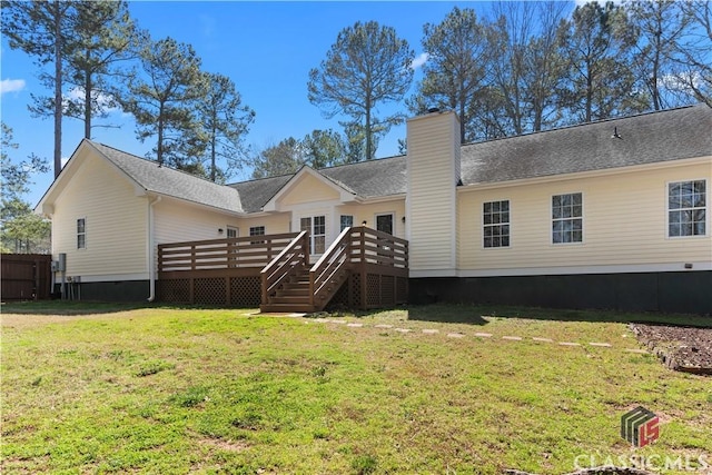 back of property featuring a wooden deck, stairs, a chimney, a yard, and crawl space