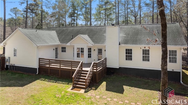 back of house featuring roof with shingles, a wooden deck, a yard, a chimney, and crawl space