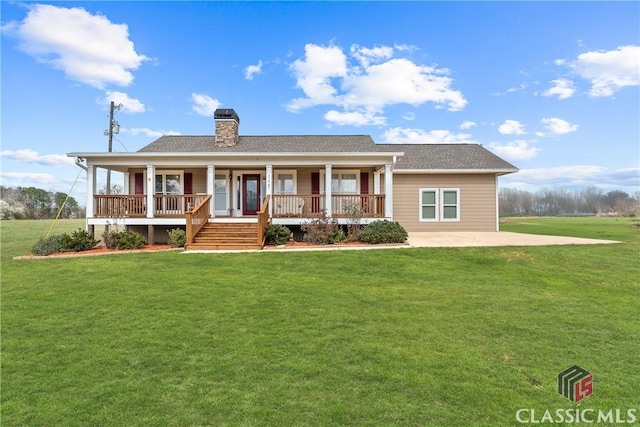 view of front of property with a porch, a chimney, a front lawn, and a shingled roof