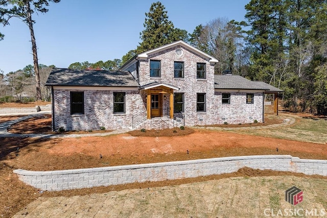 view of front of house with a front yard and brick siding