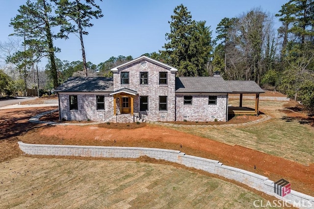 view of front of house with a front yard, stone siding, and a chimney