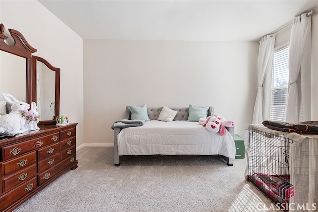 bedroom featuring light colored carpet and baseboards