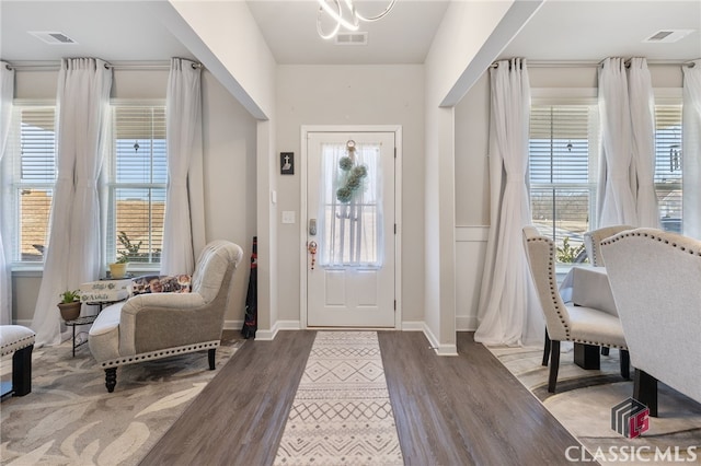 entrance foyer featuring plenty of natural light, wood finished floors, and visible vents