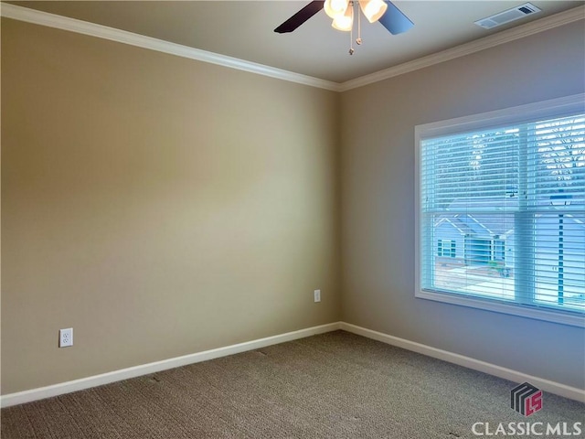 empty room with a wealth of natural light, visible vents, carpet floors, and a ceiling fan