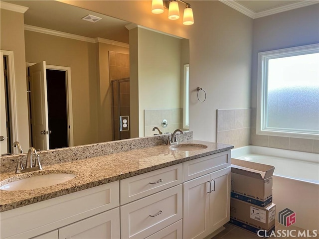 full bath with crown molding, double vanity, a stall shower, and a sink