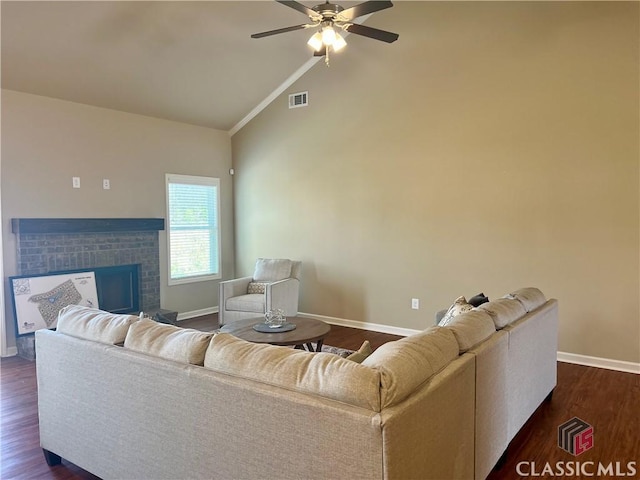 living area featuring visible vents, baseboards, a ceiling fan, and dark wood-style flooring