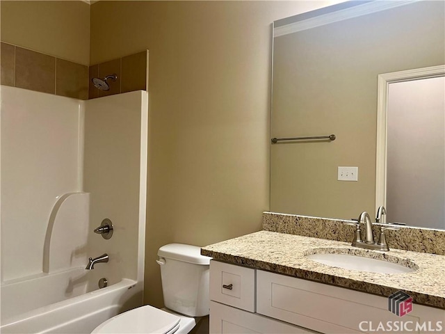 bathroom with toilet, vanity, and shower / bathtub combination