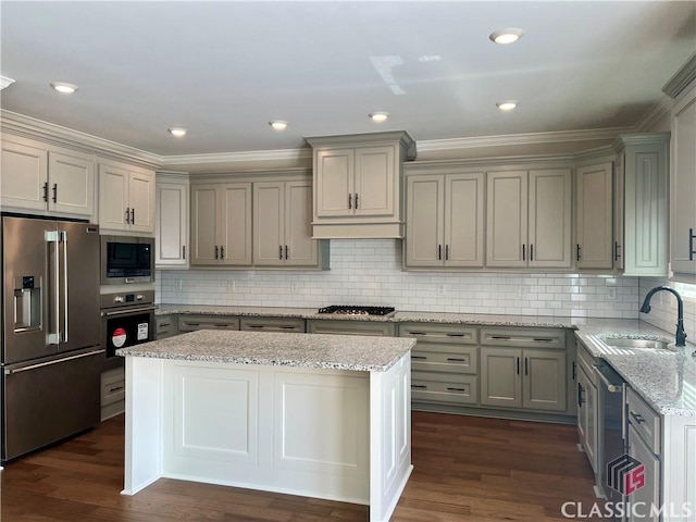 kitchen with light stone countertops, dark wood finished floors, gray cabinets, stainless steel appliances, and a sink