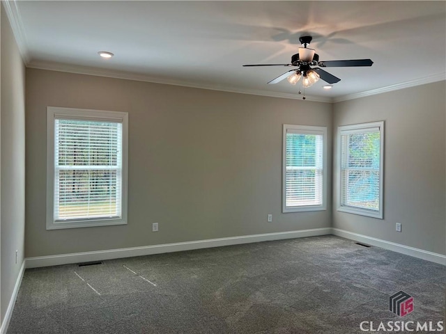 carpeted empty room featuring ceiling fan, baseboards, and ornamental molding