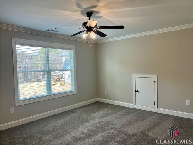 unfurnished room with a ceiling fan, visible vents, baseboards, ornamental molding, and dark carpet